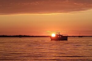 Imposter Syndrome - Is like this boat holding the sun on its bow. You know it's not real but appears that it is.