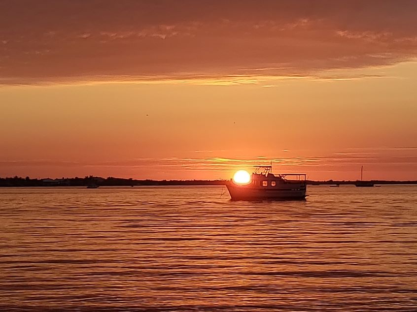 Imposter Syndrome - Is like this boat holding the sun on its bow. You know it's not real but appears that it is.