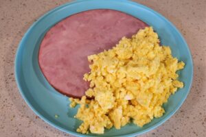 The chicken and pig are both a part of this breakfast, ham and eggs.