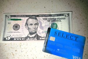 An image of a five dollar bill and credit card used for Financial Anxiety post.