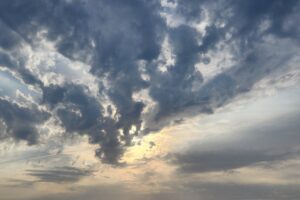 The sun is trying to break through the clouds to improve the day. A red flag day is a day with high winds and storm clouds.